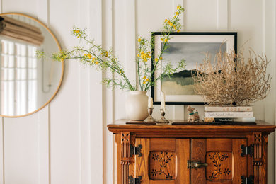 Entryway - craftsman wood wall entryway idea in Los Angeles with white walls