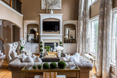 Large transitional living room photo in Atlanta with brown walls and a standard fireplace