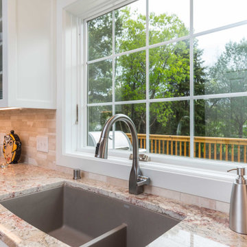 Modern Kitchen with White Flat Panel Shaker Cabinets & Natural Stone Backsplash