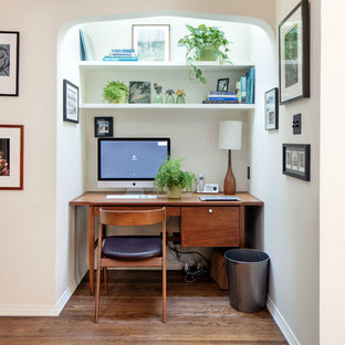 Inspiration for a medium sized mediterranean study in Los Angeles with beige walls, medium hardwood flooring, a built-in desk and brown floors.