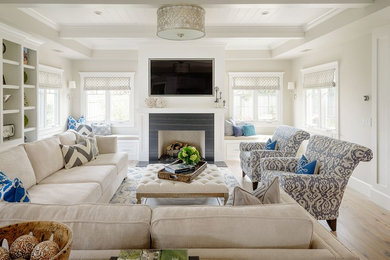 Inspiration for a large transitional enclosed light wood floor and beige floor family room remodel in San Diego with white walls, a standard fireplace, a stone fireplace and a wall-mounted tv