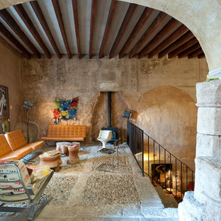Inspiration for a medium sized mediterranean mezzanine living room in Other with no tv, beige floors, beige walls, a wood burning stove and a metal fireplace surround.