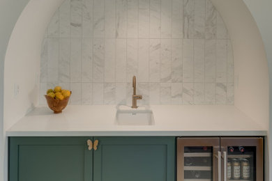 Example of a large trendy single-wall porcelain tile and white floor wet bar design in Other with an undermount sink, green cabinets, quartz countertops, white backsplash, marble backsplash, white countertops and shaker cabinets