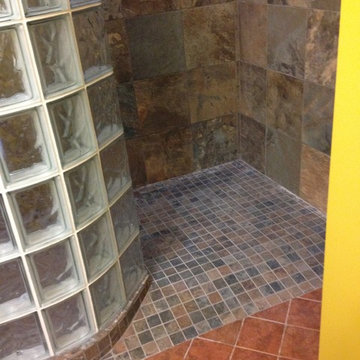 Barrier free shower base with a curved glass block wall