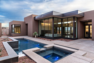 Inspiration for a mid-sized southwestern backyard concrete paver and custom-shaped lap hot tub remodel in Salt Lake City