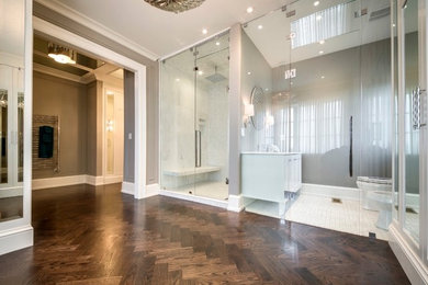 Example of a huge transitional master medium tone wood floor bedroom design in Toronto with gray walls