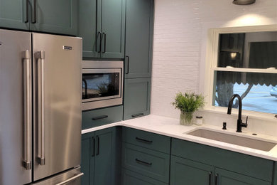 Example of a mid-sized trendy ceramic tile and gray floor kitchen design in Other with an undermount sink, shaker cabinets, green cabinets, quartz countertops, white backsplash, subway tile backsplash, stainless steel appliances and white countertops
