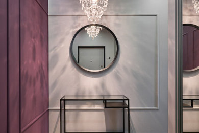 На фото: маленькая узкая прихожая: освещение в современном стиле с полом из керамической плитки, фиолетовыми стенами, серым полом и любой отделкой стен