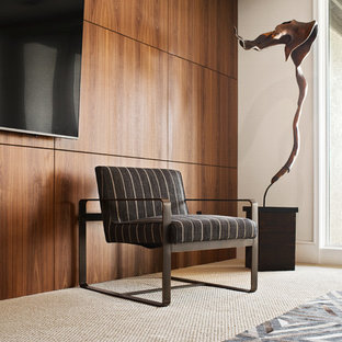 Medium sized contemporary open plan home cinema in Kansas City with multi-coloured walls, carpet, a wall mounted tv and beige floors.