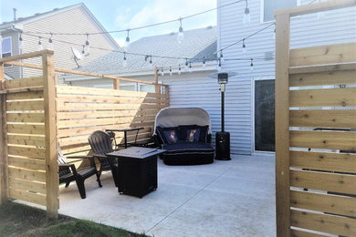 Large minimalist backyard concrete patio photo in Chicago with no cover