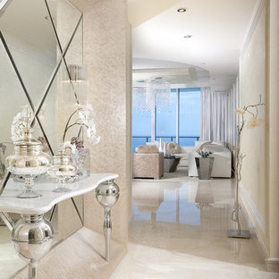 Inspiration for a mid-sized contemporary marble floor and white floor foyer remodel in Miami with beige walls