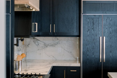 Large cottage galley light wood floor, beige floor and exposed beam eat-in kitchen photo in San Diego with a drop-in sink, shaker cabinets, black cabinets, marble countertops, multicolored backsplash, marble backsplash, paneled appliances, an island and multicolored countertops