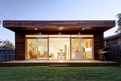 Mid-sized modern one-storey brown exterior in Melbourne with wood siding and a flat roof.