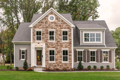 This is an example of a mid-sized transitional two-storey grey house exterior in Cleveland with mixed siding, a gable roof and a shingle roof.