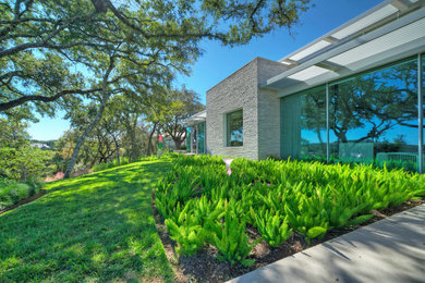 Inspiration for a large contemporary shade backyard wood fence landscaping in Austin.