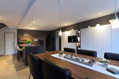 Offenes, Mittelgroßes Modernes Esszimmer ohne Kamin mit schwarzer Wandfarbe, Keramikboden und beigem Boden in Dortmund