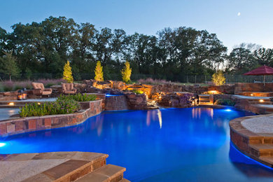 Hot tub - large traditional backyard stone and custom-shaped lap hot tub idea in Dallas