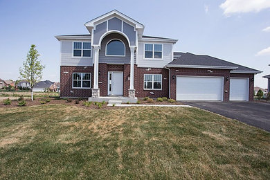 Mid-sized arts and crafts multicolored two-story mixed siding house exterior photo in Chicago with a hip roof and a shingle roof