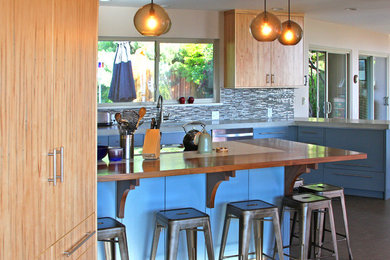 Inspiration for a mid-sized modern u-shaped laminate floor and gray floor eat-in kitchen remodel in Other with an undermount sink, flat-panel cabinets, blue cabinets, quartz countertops, multicolored backsplash, glass tile backsplash, stainless steel appliances and a peninsula