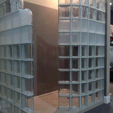 Curved glass block shower with solid surface base