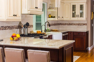 Mid-sized transitional u-shaped light wood floor and beige floor eat-in kitchen photo in Providence with beaded inset cabinets, white cabinets, a peninsula, a farmhouse sink, granite countertops, beige backsplash, stone tile backsplash, stainless steel appliances and beige countertops