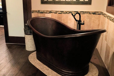 Large mountain style master multicolored tile and stone tile travertine floor bathroom photo in Calgary with shaker cabinets, distressed cabinets, a one-piece toilet, a vessel sink and granite countertops