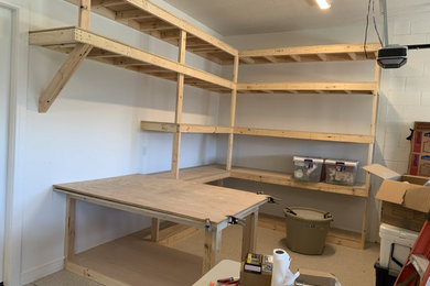 Example of a large arts and crafts attached two-car garage workshop design in Orlando