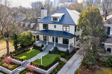 Photo of a large traditional two-storey white house exterior in Atlanta with mixed siding, a hip roof and a shingle roof.