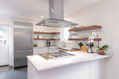 Eat-in kitchen - craftsman l-shaped ceramic tile and gray floor eat-in kitchen idea in Seattle with a single-bowl sink, open cabinets, marble countertops, white backsplash, ceramic backsplash, stainless steel appliances and a peninsula