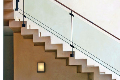 Inspiration for a contemporary staircase in Los Angeles with glass railing.