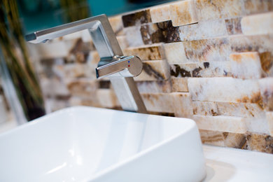 Inspiration for a mid-sized contemporary master multicolored tile and stone tile porcelain tile and beige floor bathroom remodel with furniture-like cabinets, dark wood cabinets, a wall-mount toilet, green walls, a vessel sink, quartz countertops and white countertops
