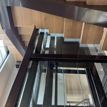 Project #136 | Modern Floating Staircase Encircling Glass Elevator