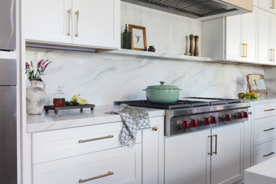 Large transitional single-wall laminate floor and brown floor kitchen photo in San Diego with shaker cabinets, white cabinets, quartz countertops, white backsplash, quartz backsplash, stainless steel appliances and white countertops