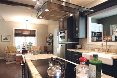 Large elegant galley ceramic tile enclosed kitchen photo in Other with a farmhouse sink, recessed-panel cabinets, black cabinets, granite countertops, beige backsplash, stone slab backsplash, stainless steel appliances and an island