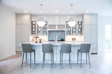 Large transitional single-wall eat-in kitchen photo in Miami with an undermount sink, shaker cabinets, gray cabinets, marble countertops, gray backsplash, stone slab backsplash, paneled appliances and an island