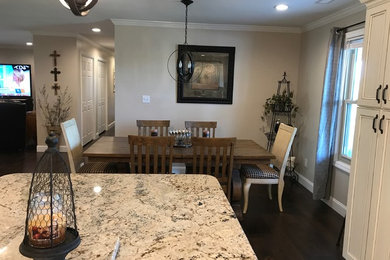 Mid-sized transitional dark wood floor and brown floor great room photo in Other with gray walls and no fireplace