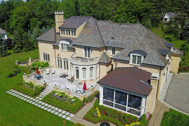Mid-sized elegant beige brick house exterior photo in New York
