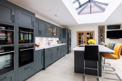 Inspiration for a large contemporary single-wall open plan kitchen in Sussex with shaker cabinets, quartz worktops and an island.