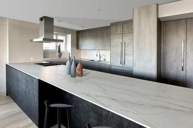 Example of a trendy kitchen design in New York with flat-panel cabinets and an island