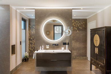 Design ideas for an asian master bathroom in Berlin with flat-panel cabinets, beige cabinets, a freestanding tub, a curbless shower, beige tile, glass sheet wall, beige walls, ceramic floors, an integrated sink, brown floor and white benchtops.