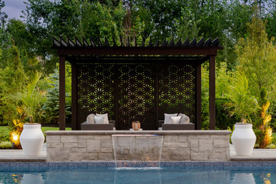 Large transitional backyard rectangular lap pool in Toronto with with a pool and concrete pavers.