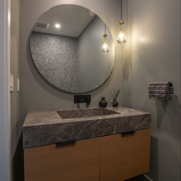 Primary Bathroom – Suspended Oak Vanity Cabinet & Large Circular Backlit Mirror