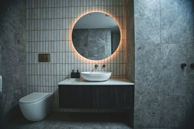 Inspiration for a mid-sized contemporary master bathroom in Melbourne with black cabinets, a freestanding tub, an open shower, a wall-mount toilet, gray tile, subway tile, engineered quartz benchtops, grey floor, an open shower, white benchtops, a niche, a single vanity and a floating vanity.