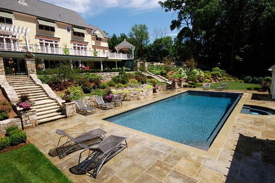 Large elegant backyard rectangular lap hot tub photo in New York with decking