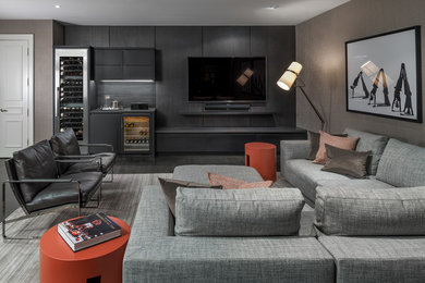 Basement - large contemporary dark wood floor and black floor basement idea in Toronto with beige walls