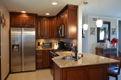 Inspiration for a timeless l-shaped porcelain tile eat-in kitchen remodel in New York with an undermount sink, raised-panel cabinets, dark wood cabinets, laminate countertops, glass sheet backsplash and stainless steel appliances