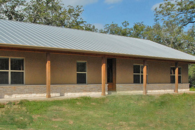 Mid-sized cottage beige one-story stucco exterior home photo in Houston