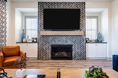 Inspiration for a rustic brick wall family room remodel in Orange County with black walls, a brick fireplace and a wall-mounted tv