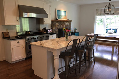 Eat-in kitchen - modern galley eat-in kitchen idea in Baltimore with white backsplash