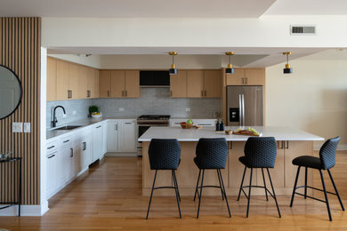 Example of a mid-sized danish medium tone wood floor eat-in kitchen design in Chicago with a single-bowl sink, flat-panel cabinets, light wood cabinets, quartz countertops, blue backsplash, subway tile backsplash, stainless steel appliances, an island and white countertops